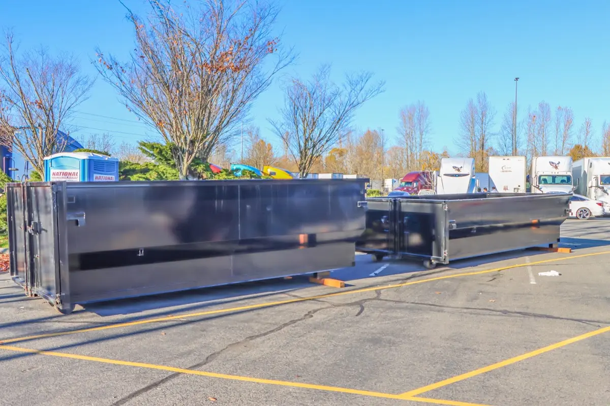 Professional dumpster rental service with roll-off container on residential driveway in Martinez